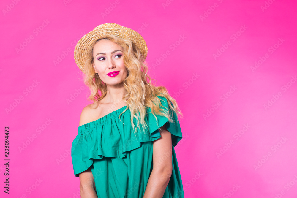 Fashion photo of a beautiful elegant young woman in a pretty dress posing over pink background. Fashion spring summer photo