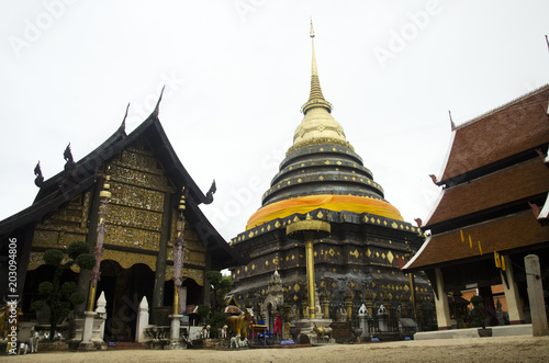 Asian thai people respect praying and walk visit chedi at Wat Phra That Lampang Luang