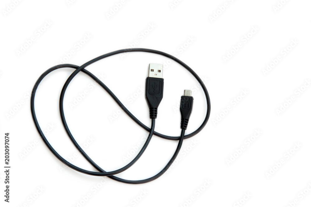 Black USB cable on white background. USB and USB-mini cable connectors close-up. Black USB cable on white background. USB and USB-mini cable connectors close-up.
