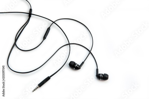 Black headphones for listening to music and sound on portable devices: music player, smartphone, laptop and jack for connection on a white background. Ear plugs.