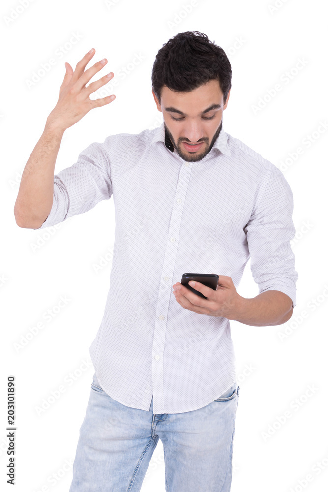 An angry young man holding his phone and raising a hand hassle with his phone, isolated on a white background. An angry young man holding his phone and raising a hand hassle with his phone, isolated on a white background.