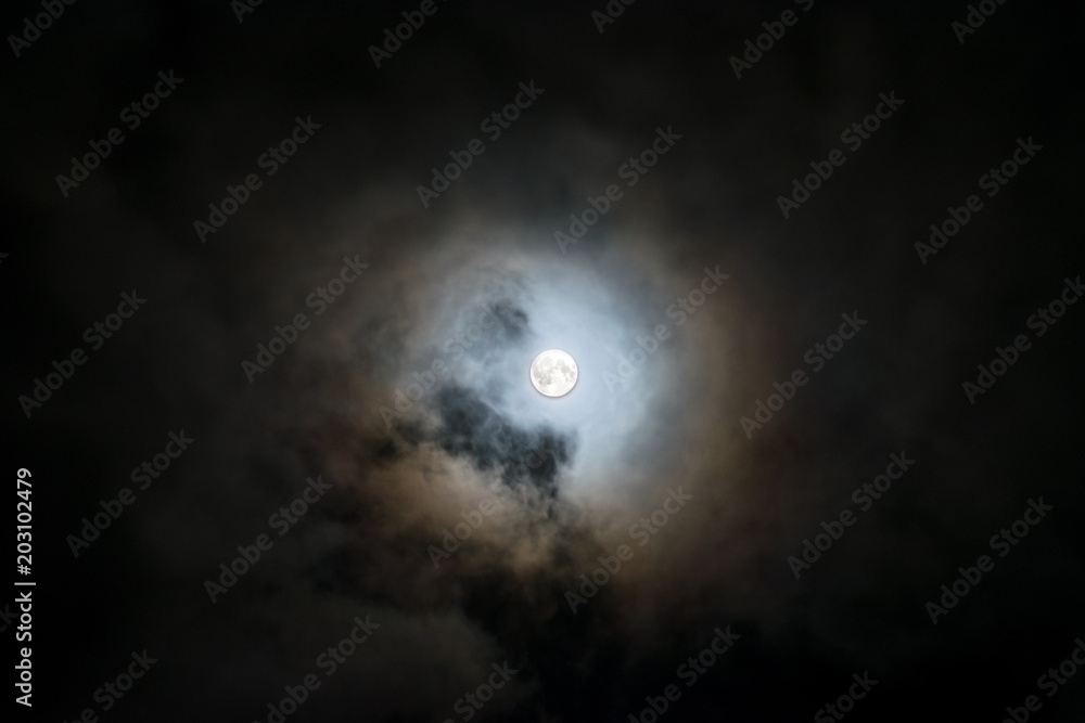 a full moon surrounded by a sea of clouds a full moon surrounded by a sea of clouds