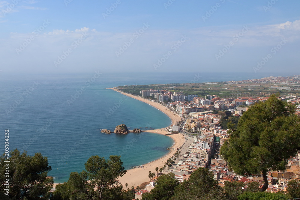 Aerial view of Blanes village and bay, taken from the top of the hill where the XIth century Sant Joan's castle and church stand, Blanes, Costa Brava, Girona, Catalonia, Spain.