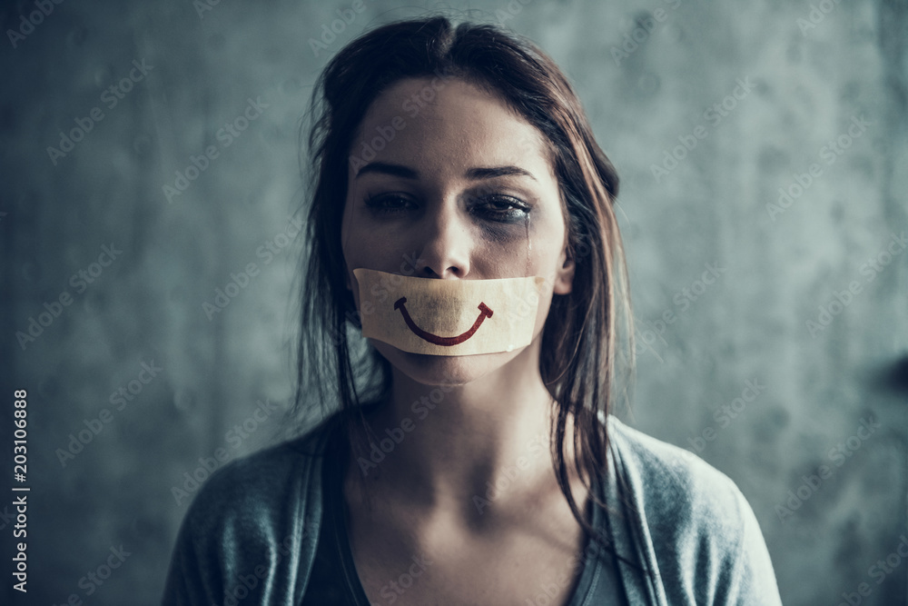 Oppressed beaten woman cries.