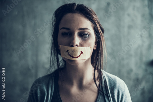 Oppressed beaten woman cries. photo