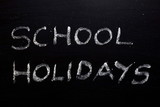 School holidays text written on chalkboard