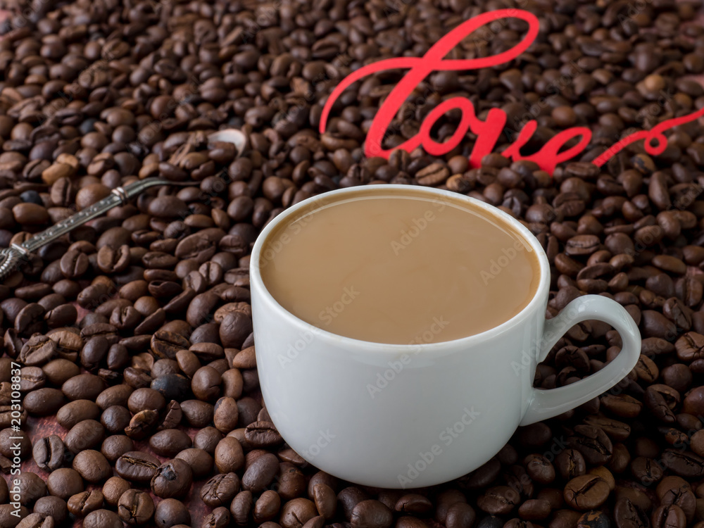 Fototapeta premium Cup of coffee with milk on background of coffee beans