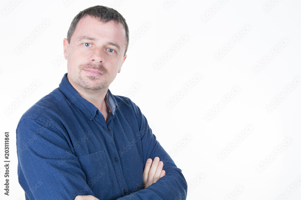 Portrait of an attractive bearded mature man crossed arms at the camera head and shoulders Portrait of an attractive bearded mature man crossed arms at the camera head and shoulders