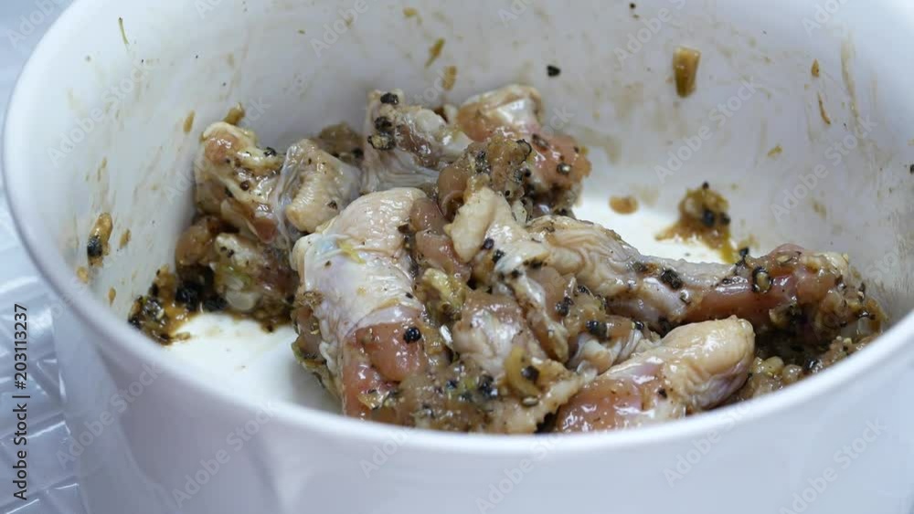 cooking marinated chicken in white bowl cooking marinated chicken in white bowl