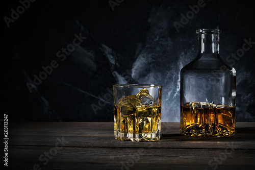 Decanter and glass of whiskey with ice