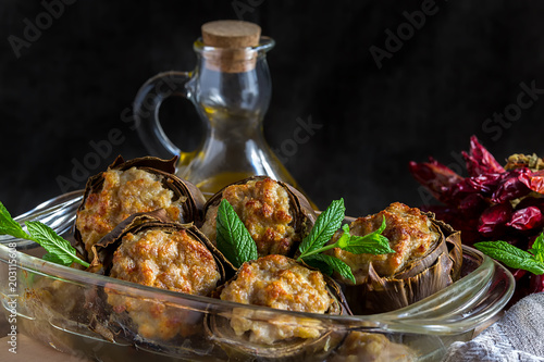 Stuffed italina artichokes on a plate with fresh mint photo