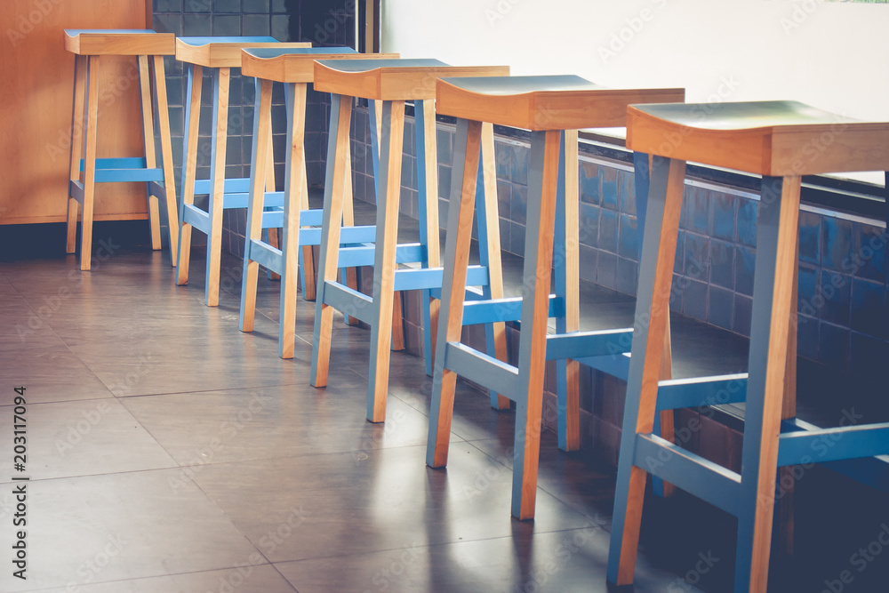 Abstract architecture row of empty vintage wooden chairs decorate in coffee cafe. (Selective focus)