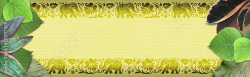 Photography Banner with leaves of tropical plants, Asian, African pattern with elephants and flowers on a yellow canvas backdrop