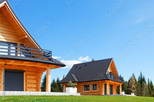 The modern ooden houses in the mountains, under a blue sky