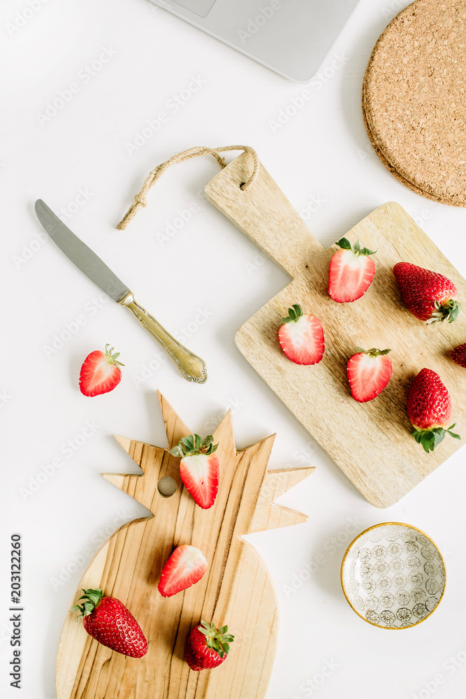 Healthy breakfast with raw strawberry on cutting board on white background. Flat lay, top view.