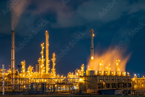 Night view over petroleum power plant industrial background.