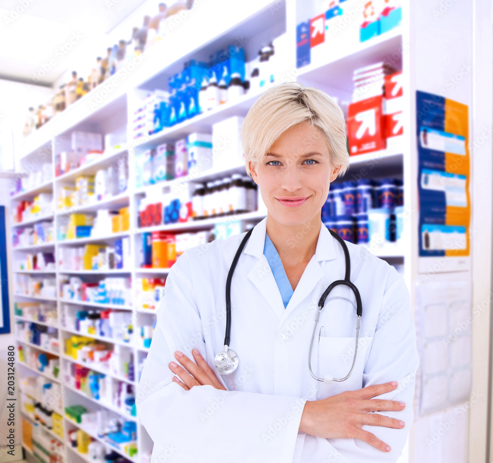 Blonde doctor smiling at camera against close up of shelves of drugs Blonde doctor smiling at camera against close up of shelves of drugs