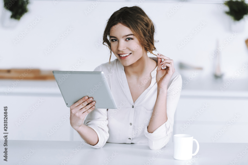 Young woman with cup of coffee is watching financial news. Young woman with cup of coffee is watching financial news.