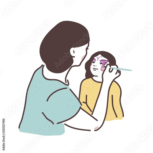A woman drawing butterfly on a face of a little girl. Body-art for kids party and workshop.