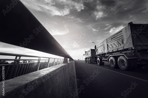 Truck on bridge at dawn.Transportation concept background.