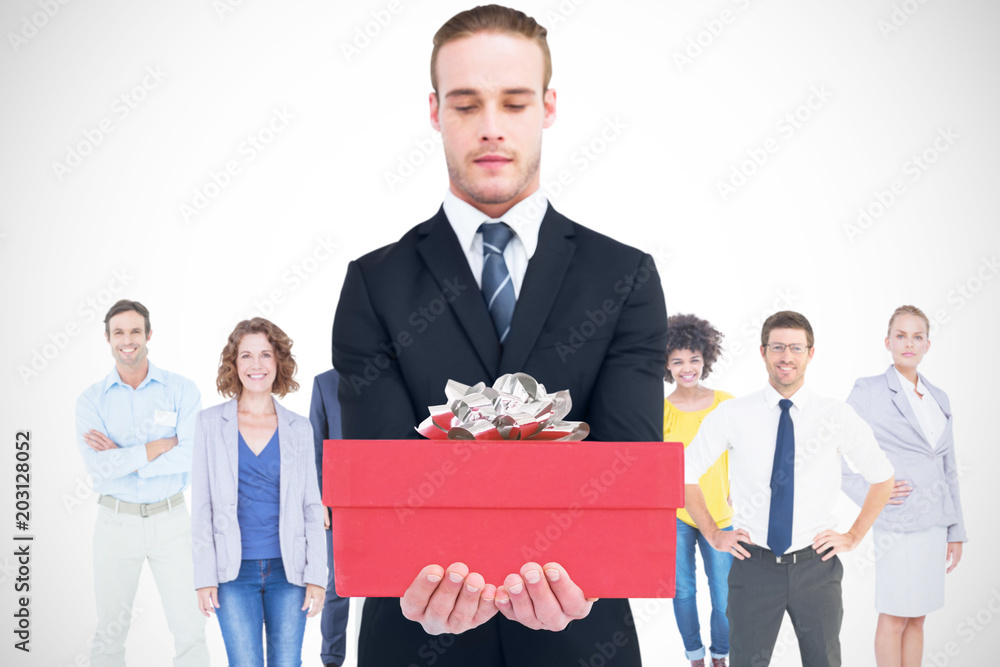 Concentrated businessman holding out his hands against present Concentrated businessman holding out his hands against present