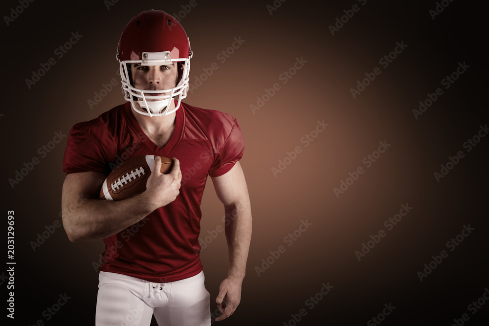 American football player with ball against orange background with vignette