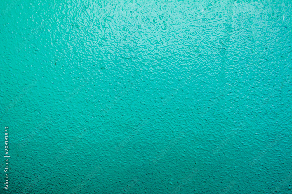 Wall painted in blue texture. Seamless texture of a light pale green concrete wall. Abstract background. Wall painted in blue texture. Seamless texture of a light pale green concrete wall. Abstract background.
