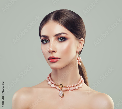 Fashion Portrait of Young Woman with Makeup and Pink Agate Necklace and Earrings