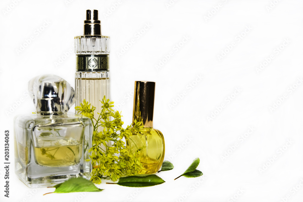 Perfume with blossoming linden branch on white background closeup Perfume with blossoming linden branch on white background closeup