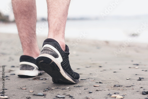 Man healthy jogging at the beach. Concept to life and health.