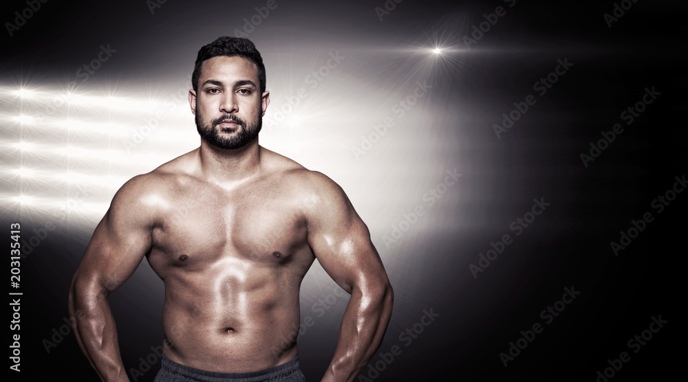 Portrait of a bodybuilder man flexing muscles against lens flare Portrait of a bodybuilder man flexing muscles against lens flare