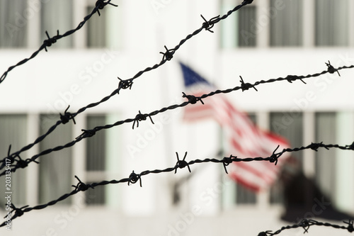 Barbed wire in the foreground and the blurred American flag in the background. Manhattan  New York city  USA.