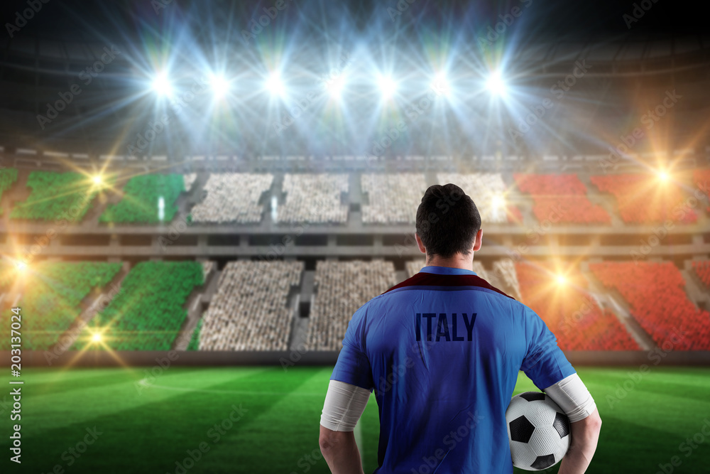 Italy football player holding ball against stadium full of italy football fans
