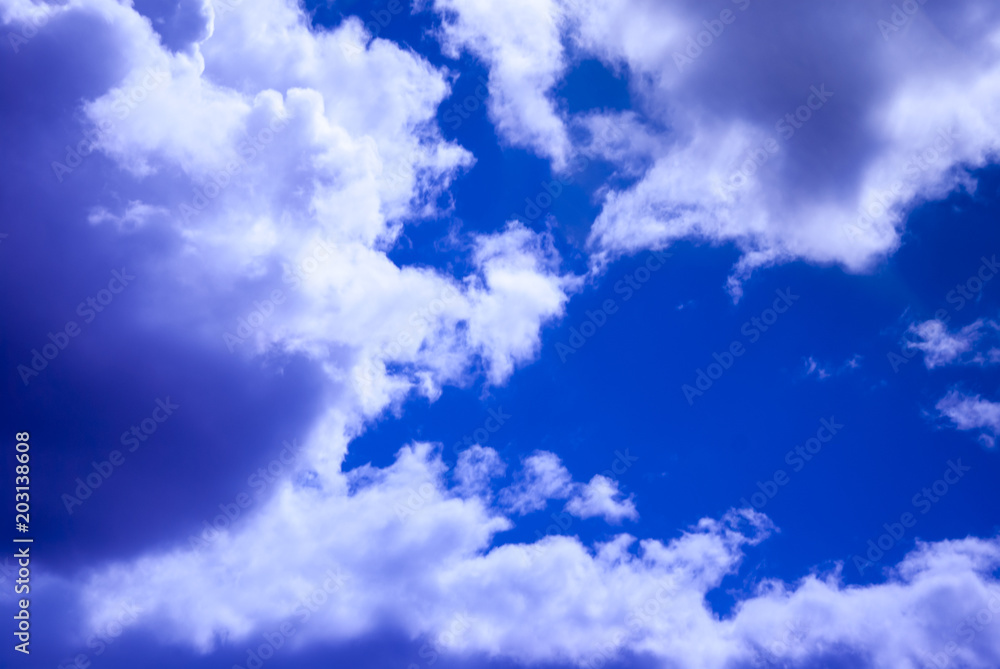 Contrast white and vanilla dense clouds against the blue sky Contrast white and vanilla dense clouds against the blue sky