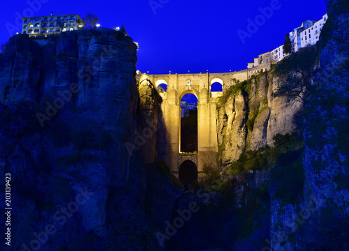 Ancient stone bridge in night. Ronda, Spain