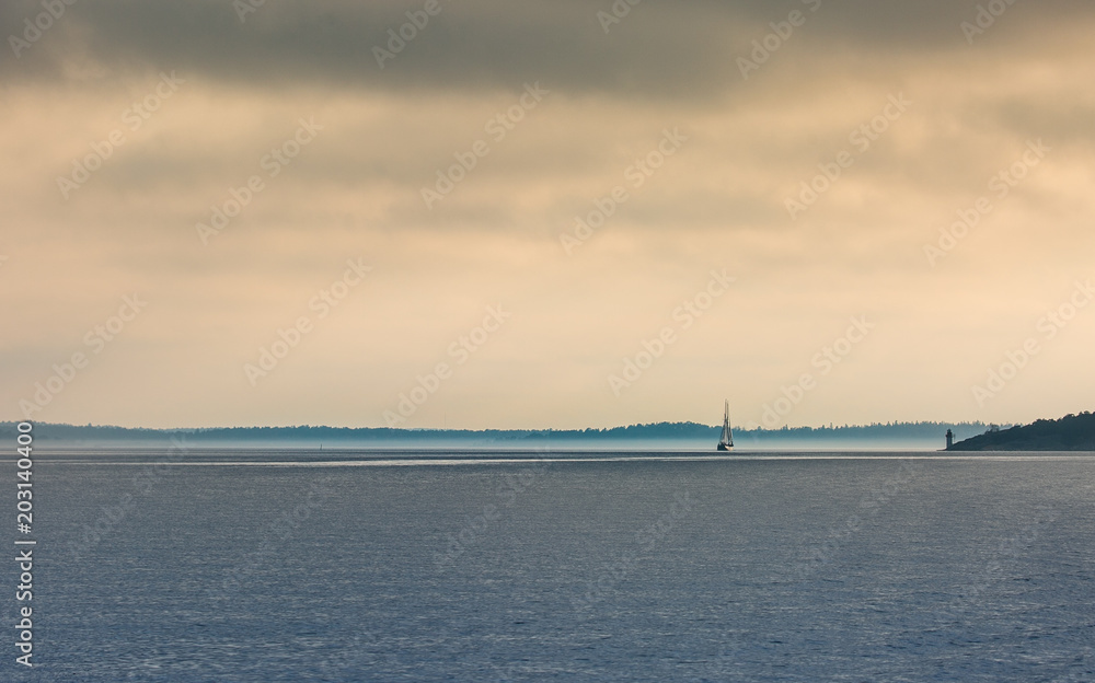 Lonely sailing ship at the horizon