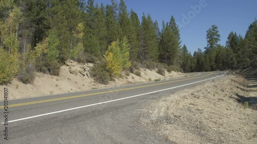 Right Side view of a Driving Plate: Car turns left onto Silver Lake Road (County Road 676) near Shellock Draw Road sign in Klamath County, Oregon, and travels through high desert forest and meadow toward Chiloquin, Oregon. photo