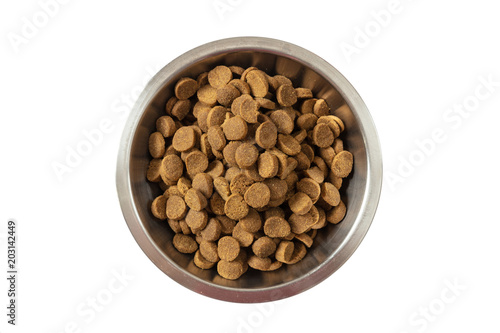 Dogs or cats dry food in a metal bowl isolated on white background, top view