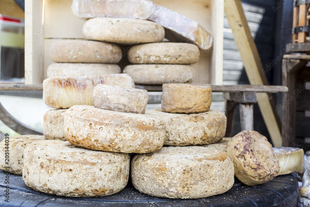 rustic french cheese wheels stacked on the marketplace rustic french cheese wheels stacked on the marketplace