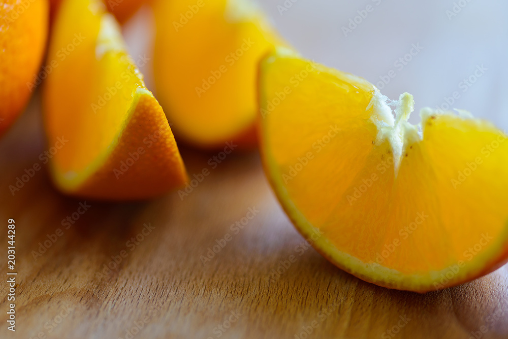Oranges cut and set on wooden cutting board Oranges cut and set on wooden cutting board