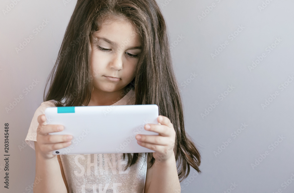 leisure, childhood, technology and people concept - cute little girl child with gadget. leisure, childhood, technology and people concept - cute little girl child with gadget.