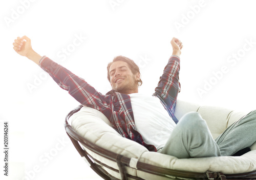 stylish guy stretching in a comfortable chair
