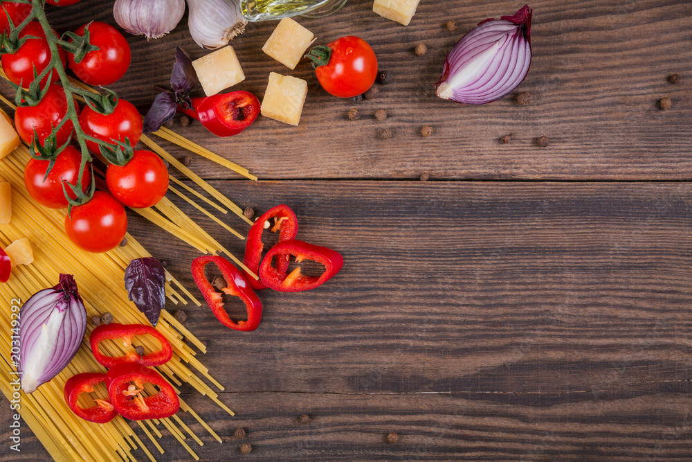 Ingredients for cooking spaghetti - raw pasta, tomato, olive oil, spices, herbs Ingredients for cooking spaghetti - raw pasta, tomato, olive oil, spices, herbs