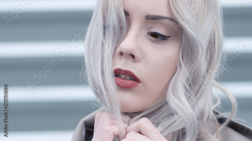 Cold portrait of young blonde with red lips