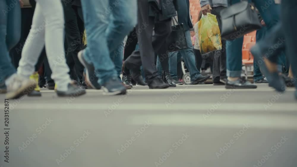 People pedestrians walks across a busy city street. People pedestrians walks across a busy city street.