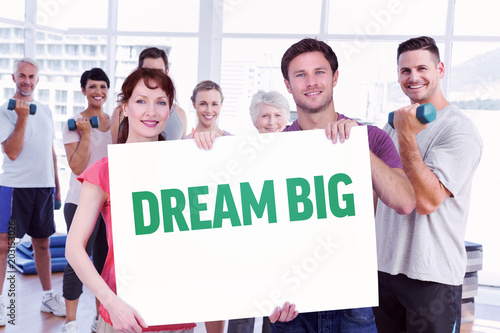 Couple holding a white sign against dream big © vectorfusionart