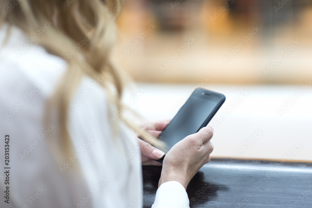 Young woman operating a smartphone. Close-up of hands Young woman operating a smartphone. Close-up of hands