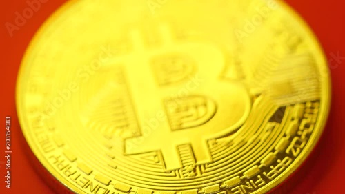 Focusing of beautiful golden bitcoin in and out photo