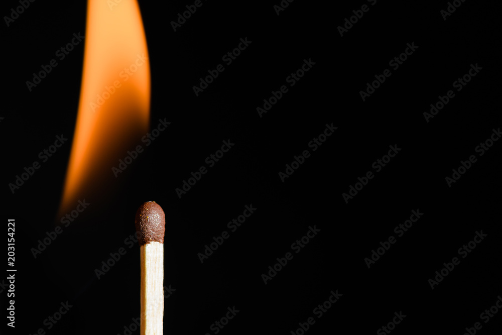 The match on fire on black background close-up The match on fire on black background close-up