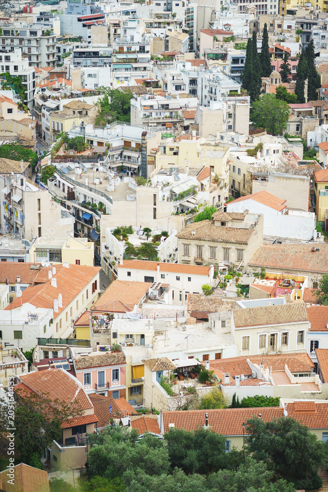 View from above on the streets and roofs of the houses of a modern European city. Athens summer day from a height.